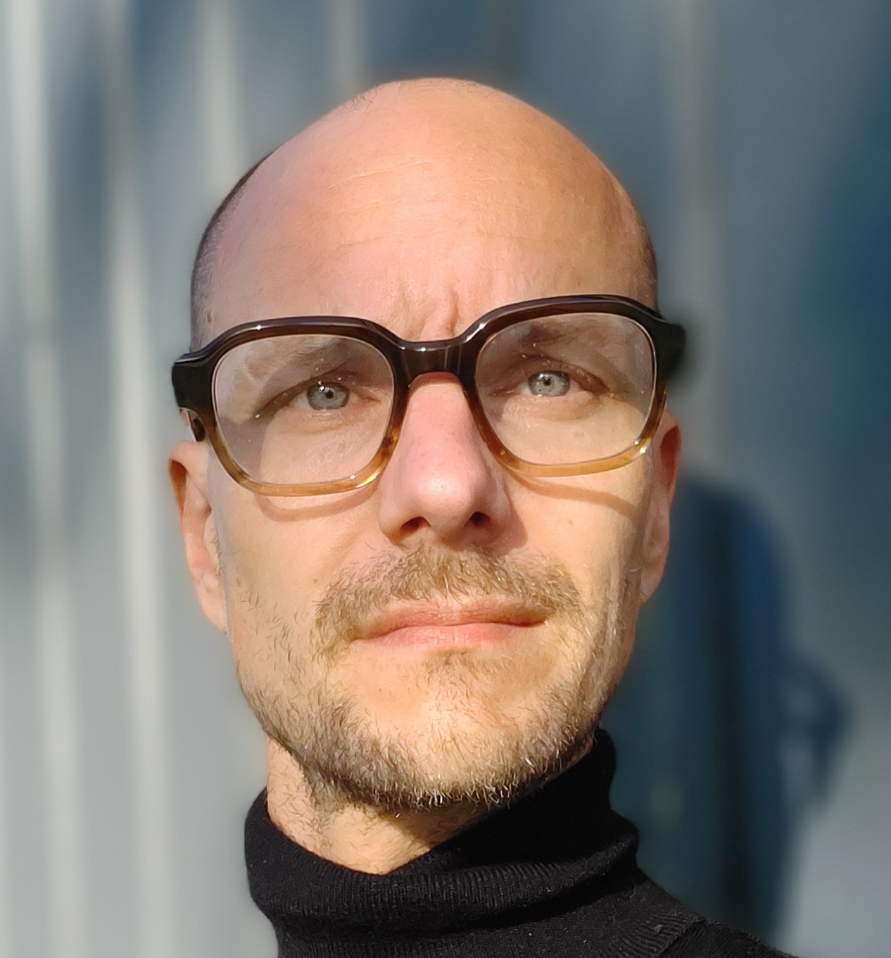 Portrait of Pekka Mertala wearing glasses